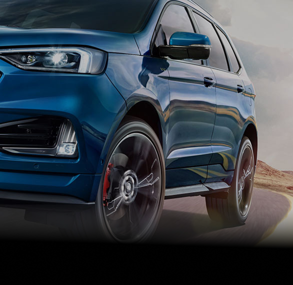 Blue SUV driving on a winding mountain road