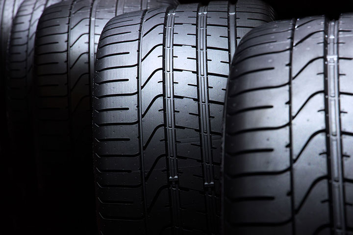 Close-up of new car tyres showcasing detailed tread patterns for optimal road performance